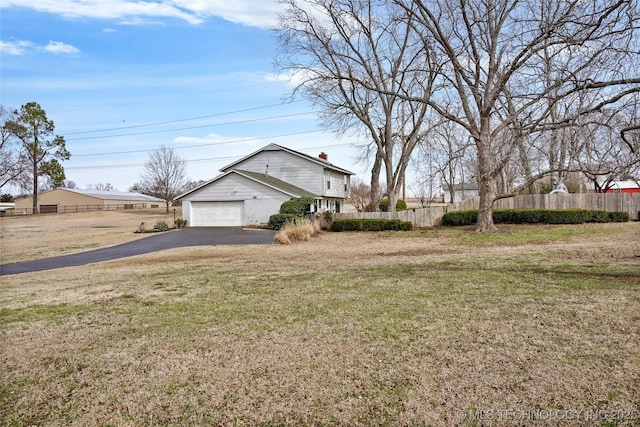 view of yard with a garage and fence