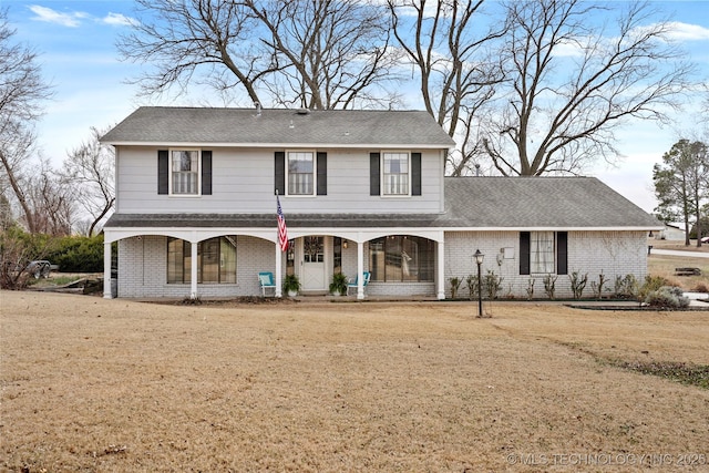 view of front facade featuring a porch, brick siding, and a shingled roof