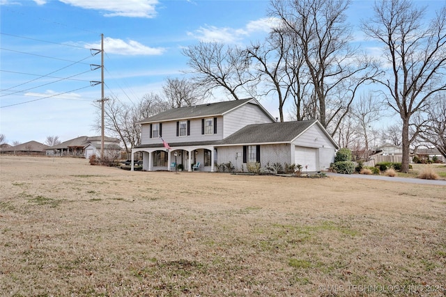 view of front facade featuring a front yard, covered porch, and an attached garage