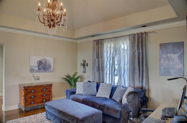 living area with a tray ceiling, ornamental molding, wood finished floors, and a chandelier