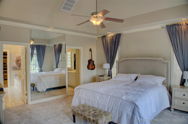 bedroom featuring visible vents, carpet flooring, crown molding, and a ceiling fan