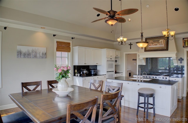 dining space with dark wood-style flooring and a ceiling fan