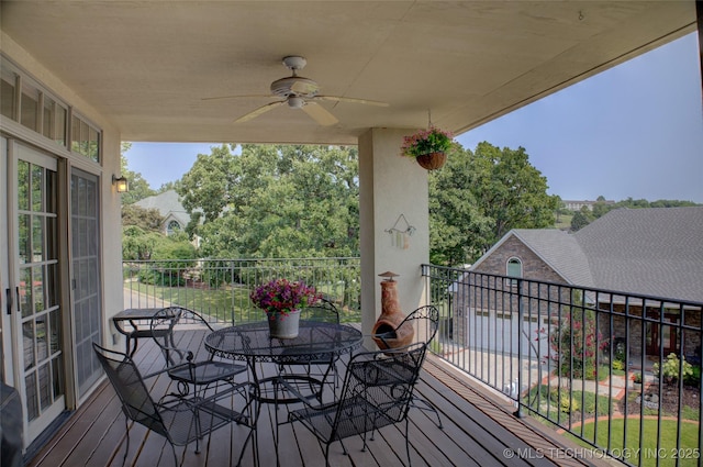 wooden terrace with a ceiling fan