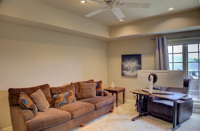 living area featuring baseboards, recessed lighting, light colored carpet, and a ceiling fan