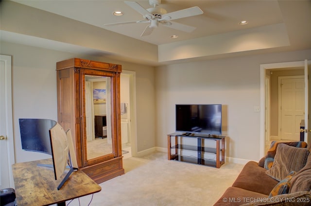 carpeted living room featuring recessed lighting, baseboards, a tray ceiling, and a ceiling fan