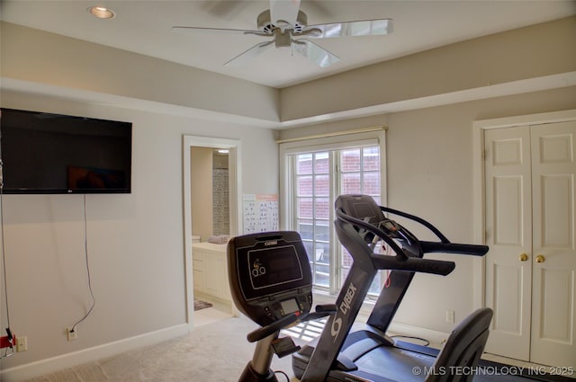 exercise area featuring baseboards, ceiling fan, and carpet floors