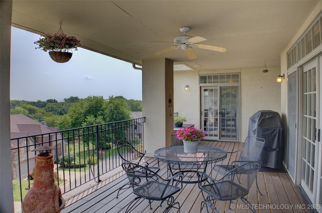 wooden terrace featuring grilling area and ceiling fan