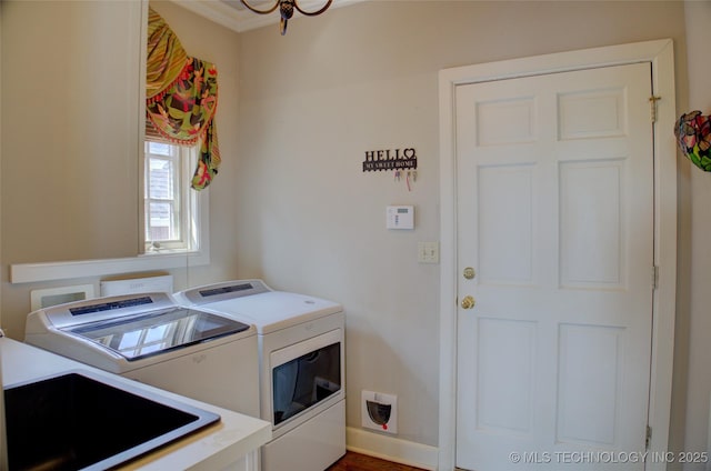 clothes washing area with laundry area, independent washer and dryer, and a sink