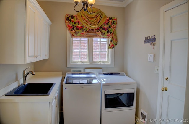 washroom with a sink, cabinet space, and washing machine and clothes dryer