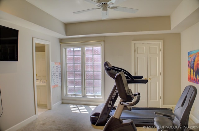 workout room featuring carpet flooring, baseboards, and a ceiling fan