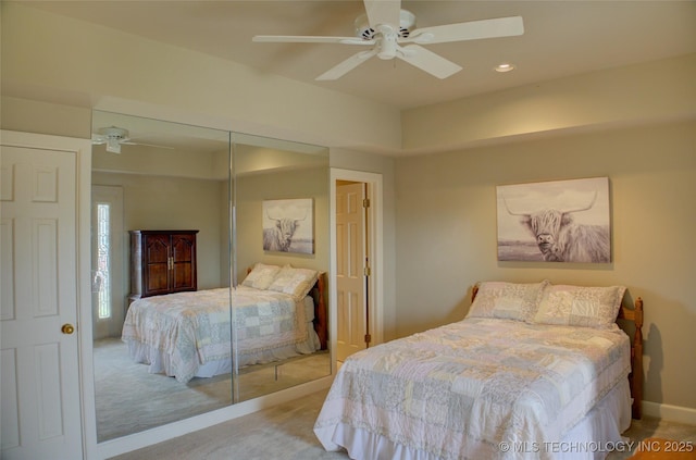 bedroom with a closet, recessed lighting, carpet, and a ceiling fan