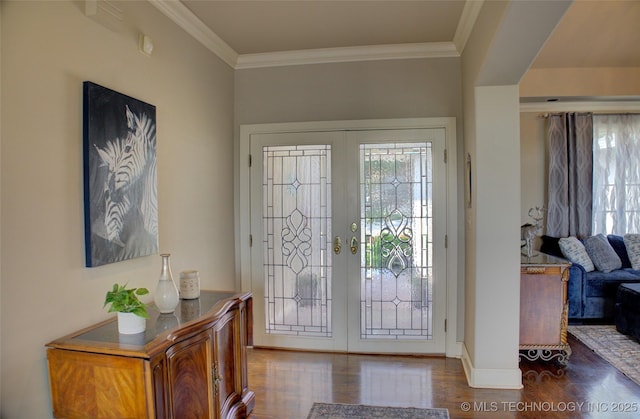 foyer featuring french doors, wood finished floors, and ornamental molding