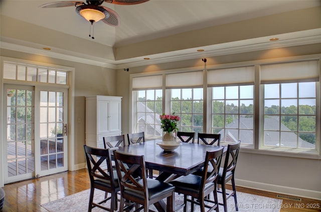 dining space featuring visible vents, baseboards, a ceiling fan, and crown molding