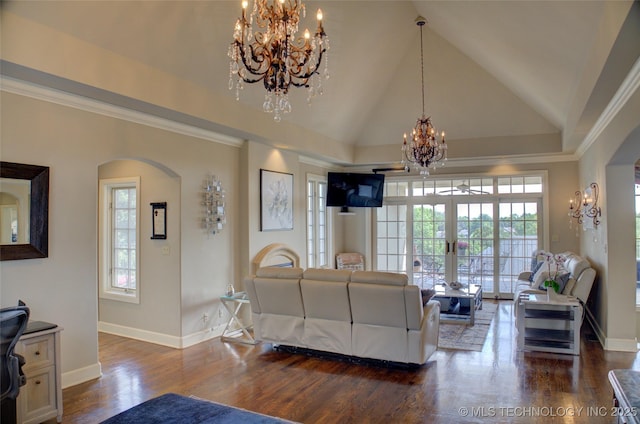 living room featuring baseboards, arched walkways, a chandelier, and dark wood finished floors