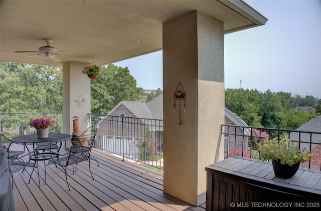 wooden terrace featuring a ceiling fan