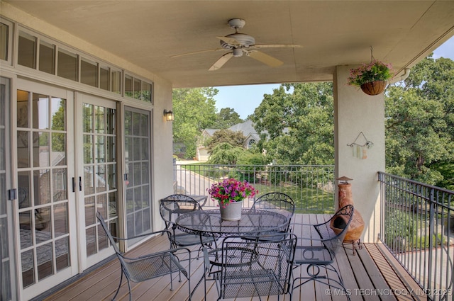 wooden terrace with a ceiling fan