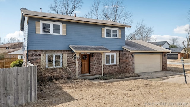 traditional-style home with brick siding, fence, driveway, and an attached garage