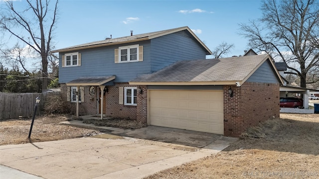 traditional home with a garage, concrete driveway, brick siding, and fence