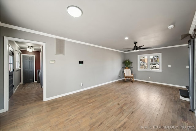 unfurnished room with baseboards, visible vents, hardwood / wood-style flooring, ceiling fan, and crown molding