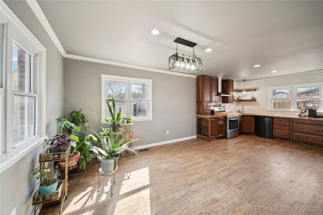 kitchen featuring black dishwasher, stainless steel stove, light wood-style flooring, a sink, and wall chimney range hood