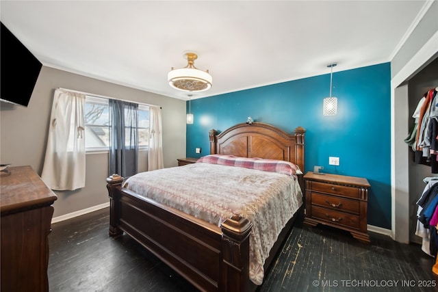 bedroom with dark wood-style flooring, a closet, and baseboards