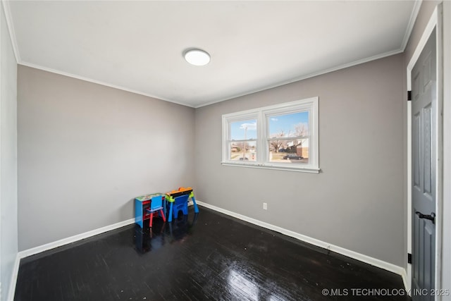 game room with crown molding, baseboards, and wood finished floors