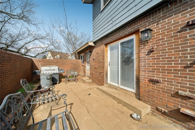 view of patio with fence and area for grilling