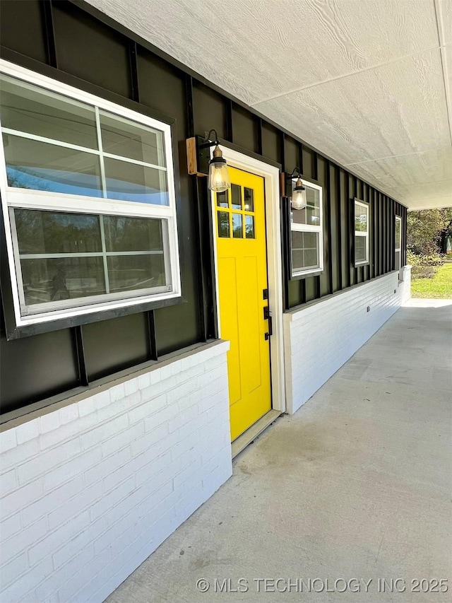 doorway to property with brick siding