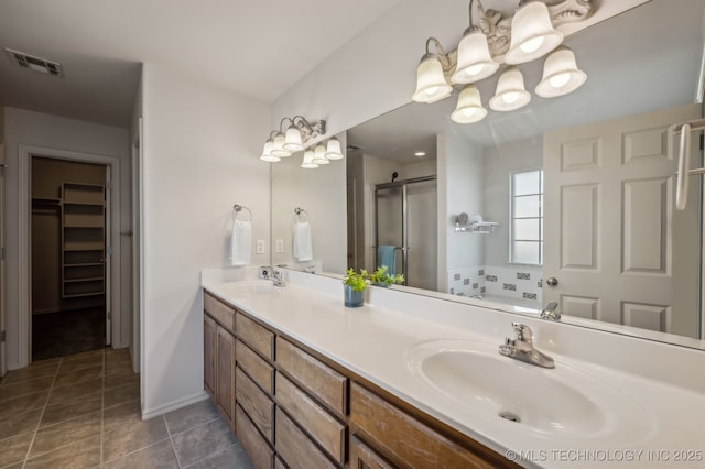 bathroom featuring a shower stall, visible vents, a sink, and tile patterned floors