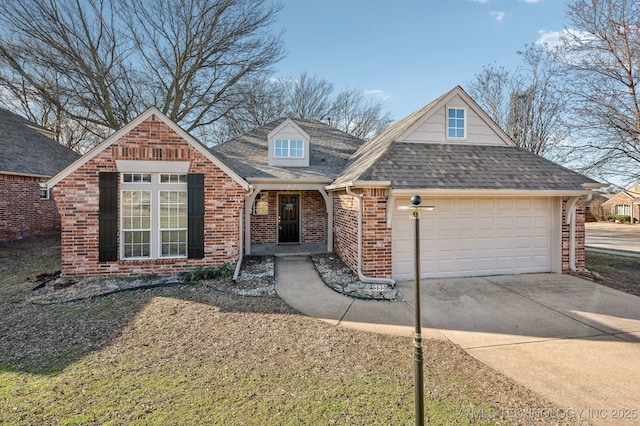 view of front facade featuring a garage, roof with shingles, concrete driveway, and brick siding