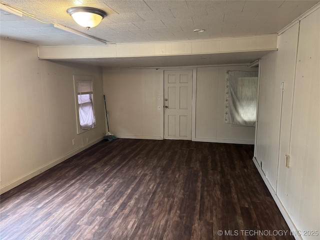 interior space featuring wood finished floors and baseboards