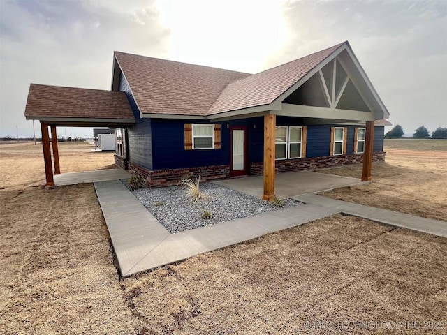 view of front of home featuring roof with shingles