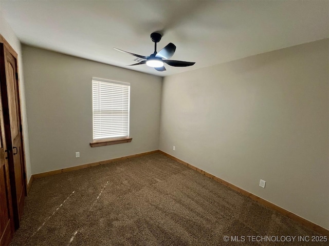 carpeted empty room with ceiling fan and baseboards