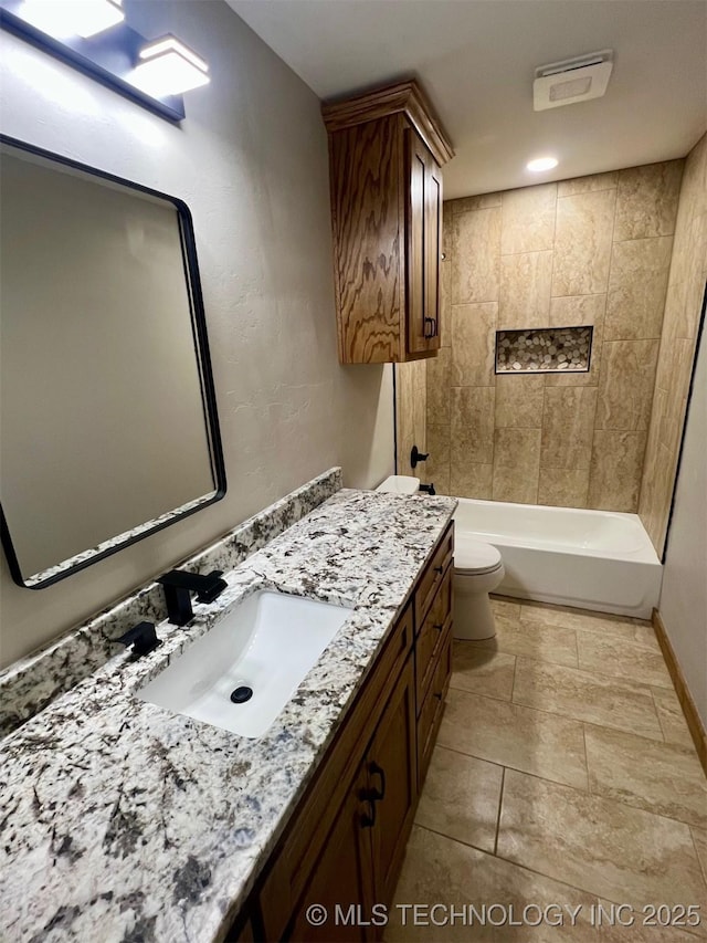 bathroom featuring baseboards, vanity, and toilet