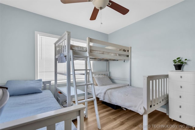 bedroom with ceiling fan and wood finished floors