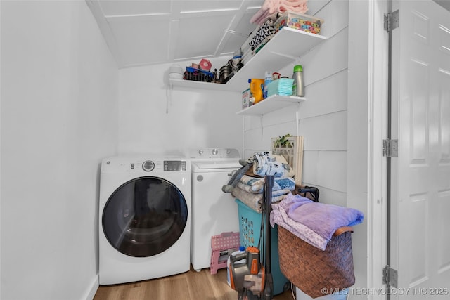 laundry room with laundry area, independent washer and dryer, and wood finished floors