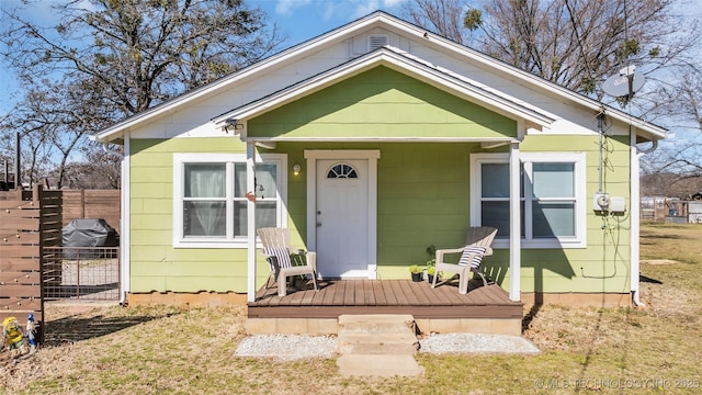 bungalow-style house with a porch and fence