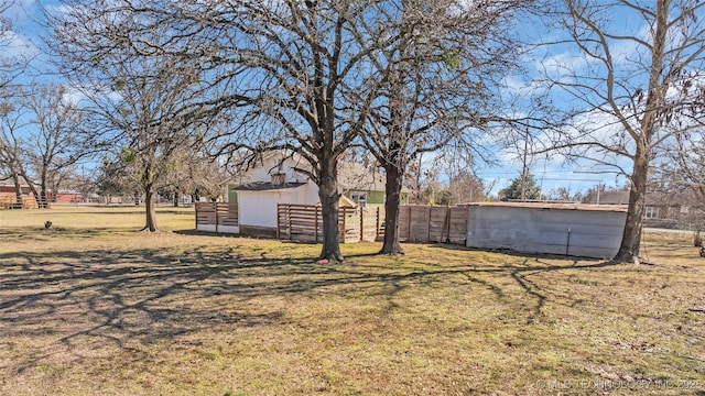 view of yard with an outbuilding and fence