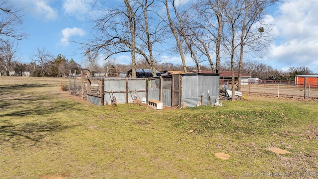 view of yard with an outbuilding and fence