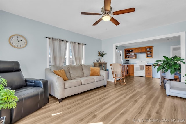 living room with light wood-type flooring and ceiling fan