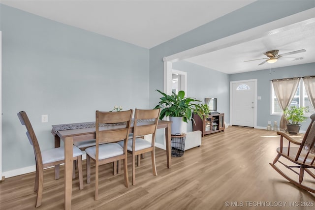 dining area featuring light wood-type flooring, ceiling fan, and baseboards