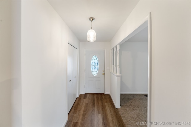 entryway featuring dark wood-type flooring and baseboards