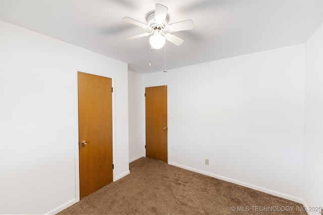 unfurnished room featuring ceiling fan, carpet floors, and baseboards