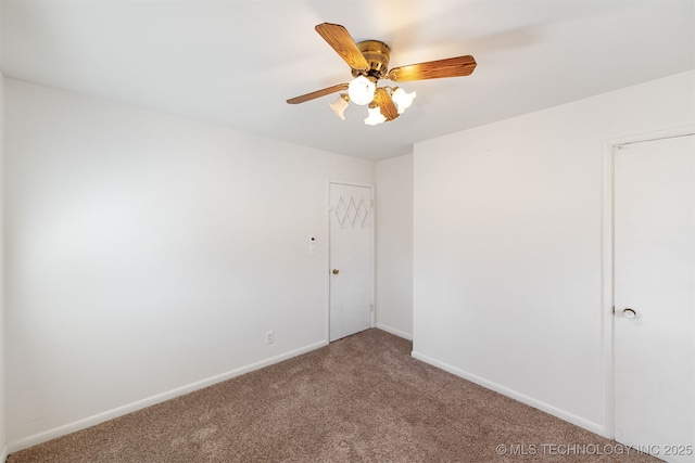 empty room with carpet, baseboards, and a ceiling fan