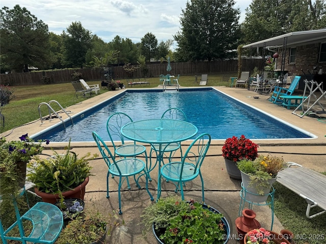 view of swimming pool featuring a lawn, a patio area, a fenced backyard, and a fenced in pool