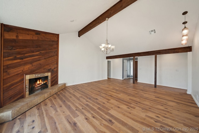 9435 S 33rd W Ave, Tulsa, OK 74132 - unfurnished living room featuring a chandelier, a fireplace, wood finished floors, and baseboards