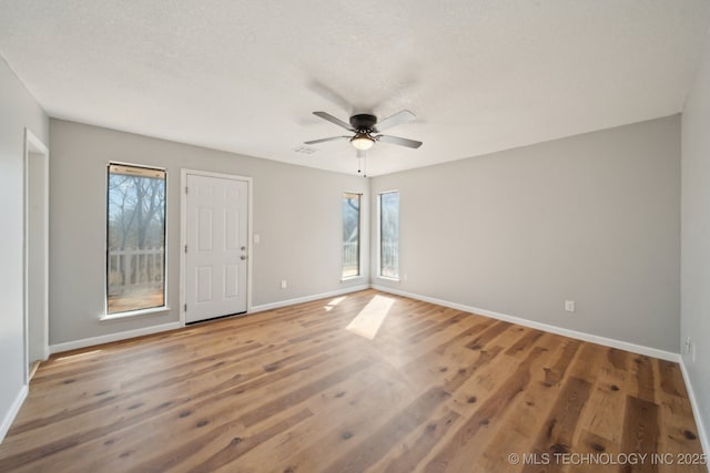9435 S 33rd W Ave, Tulsa, OK 74132 - unfurnished room featuring baseboards, plenty of natural light, ceiling fan, and a textured ceiling