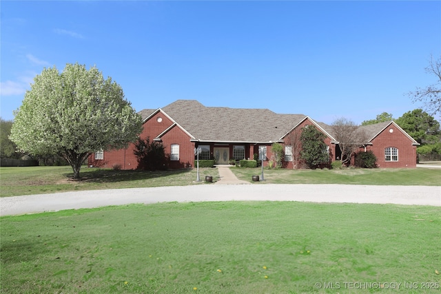 view of front of home with brick siding and a front lawn