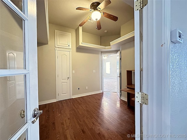 hall with baseboards and wood finished floors