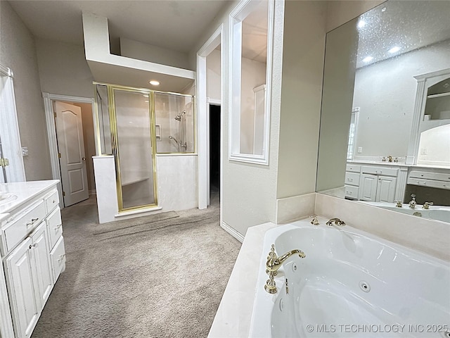 full bathroom featuring a stall shower, a jetted tub, and vanity